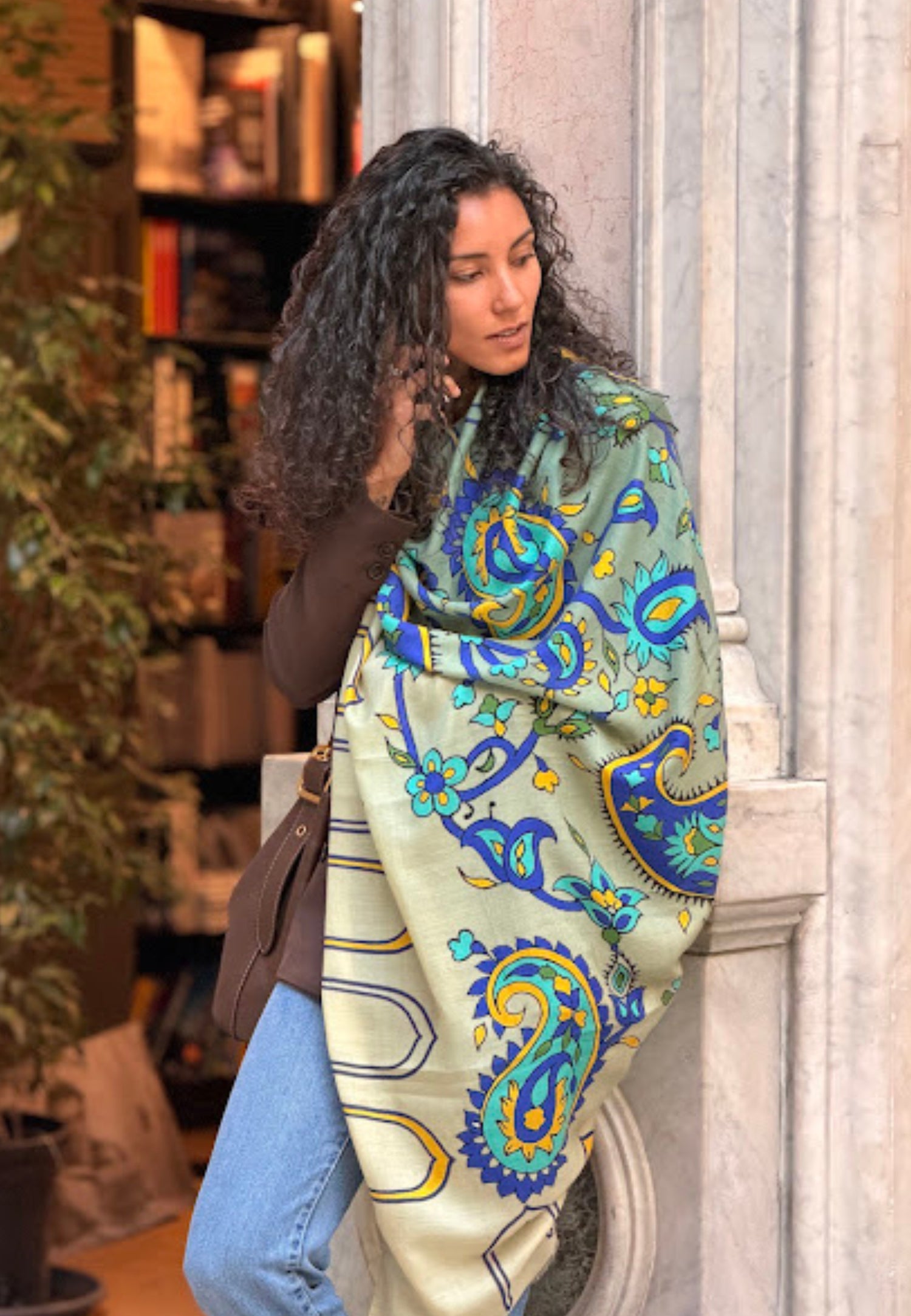Woman wearing a colorful paisley scarf in an urban setting