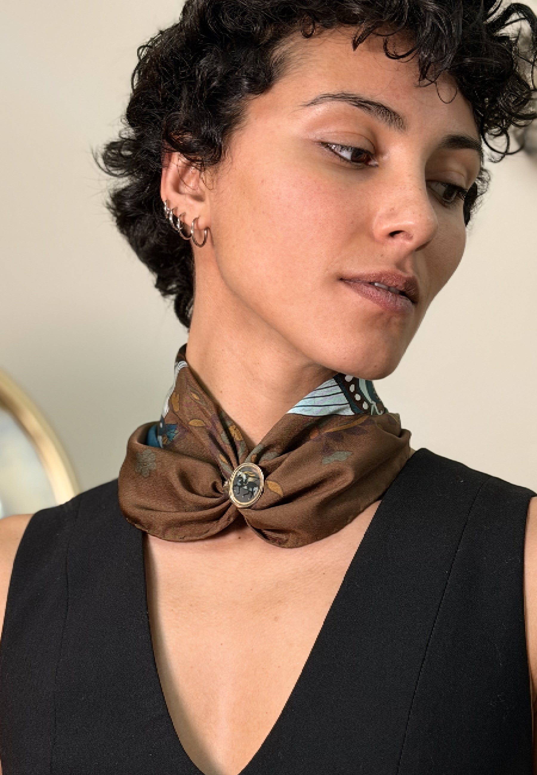 A close-up of a woman wearing a brown silk tied with pari-dar ilver ring